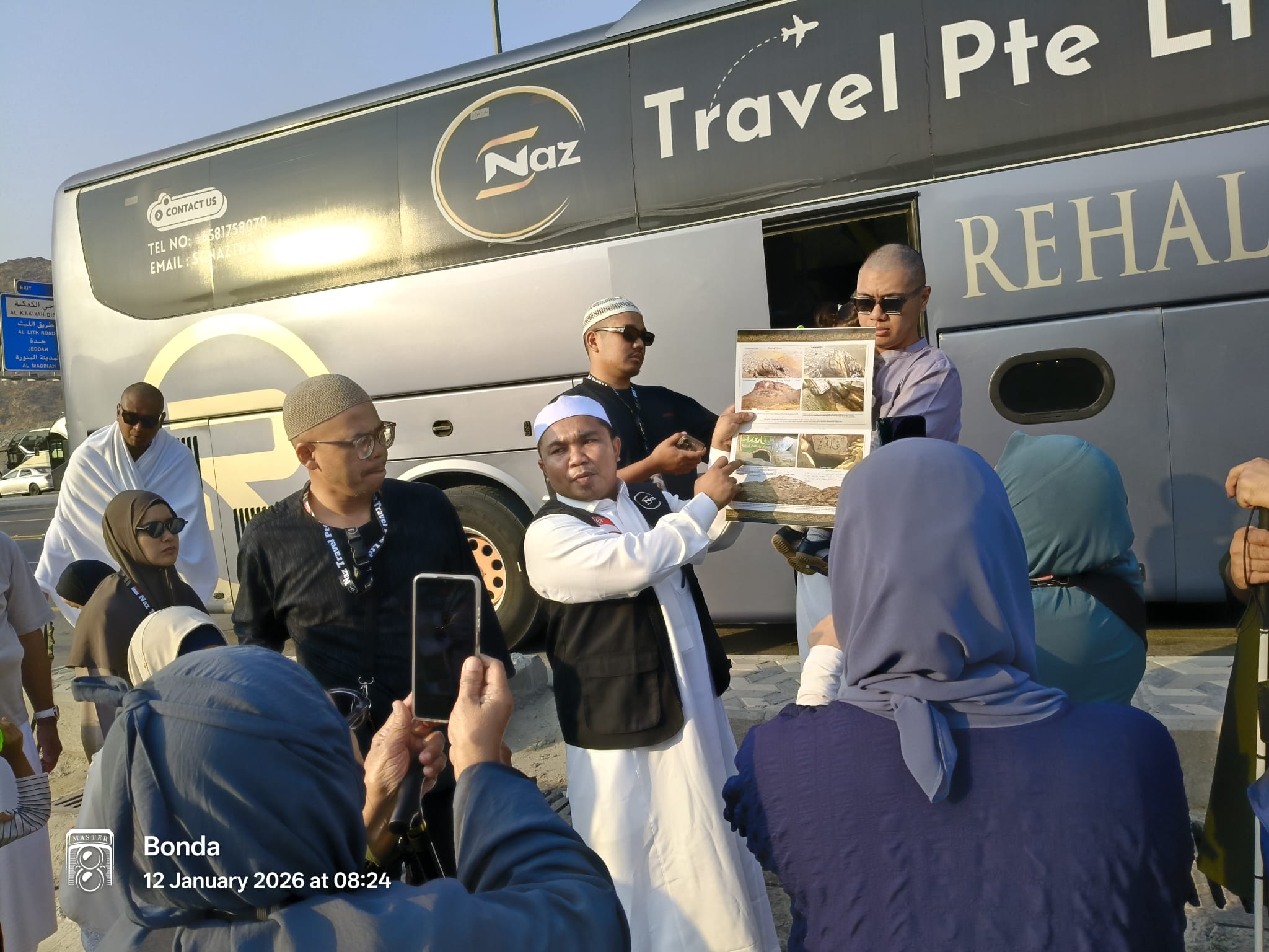 Naz Travel briefing session near coach bus
